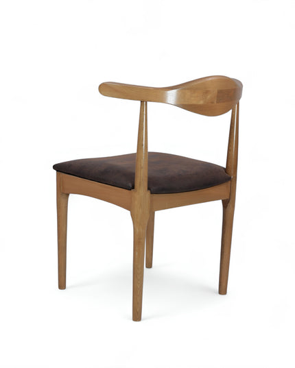 Mid-century modern wooden dining chair with sculpted backrest and brown leather seat cushion — ideal for vintage-inspired interiors, dining rooms, and boutique cafes.