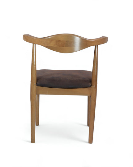 Mid-century modern wooden dining chair with sculpted backrest and brown leather seat cushion — ideal for vintage-inspired interiors, dining rooms, and boutique cafes.