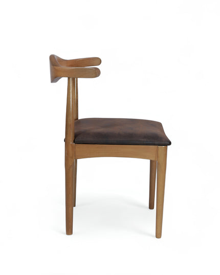 Mid-century modern wooden dining chair with sculpted backrest and brown leather seat cushion — ideal for vintage-inspired interiors, dining rooms, and boutique cafes.