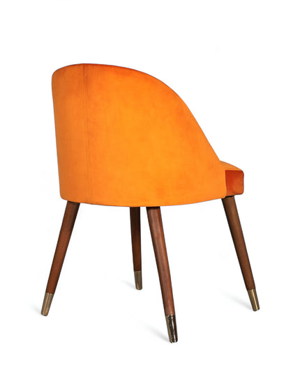 Modern orange velvet dining chair with wooden legs and golden tips— ideal for contemporary interiors, dining rooms, or statement seating.