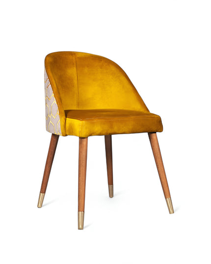 Modern mustard yellow velvet dining chair with wooden legs and gold metal tips, featuring patterned fabric back — ideal for contemporary interiors, dining rooms, or statement seating.