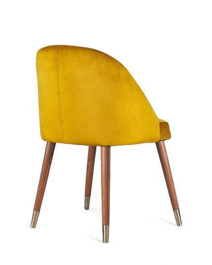 Modern mustard velvet dining chair with wooden legs and golden tips— ideal for contemporary interiors, dining rooms, or statement seating.