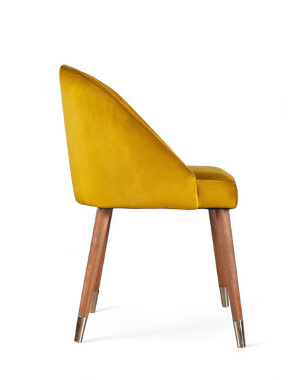 Modern mustard velvet dining chair with wooden legs and golden tips— ideal for contemporary interiors, dining rooms, or statement seating.