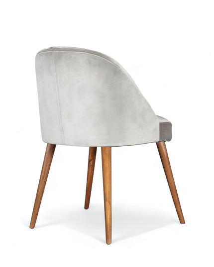 Modern silver velvet dining chair with wooden legs— ideal for contemporary interiors, dining rooms, or statement seating.