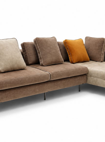 Amberley modern L-shaped sectional sofa with chaise lounge, neutral beige and taupe upholstery, amber accent cushion, included back cushions and slim metal legs.