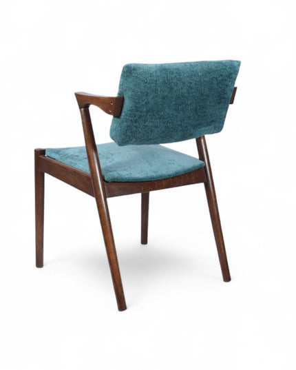 Mid-century modern accent chair with an angular dark wood frame and teal textured upholstery on the seat and backrest, ideal for dining areas, home offices, or stylish living spaces.
