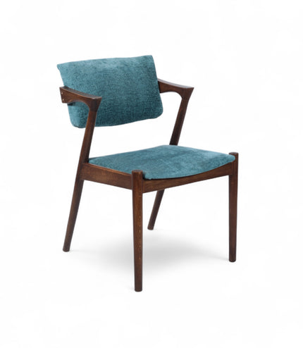 Mid-century modern accent chair with an angular dark wood frame and teal textured upholstery on the seat and backrest, ideal for dining areas, home offices, or stylish living spaces.