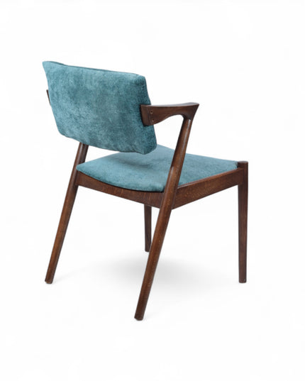 Mid-century modern accent chair with an angular dark wood frame and teal textured upholstery on the seat and backrest, ideal for dining areas, home offices, or stylish living spaces.