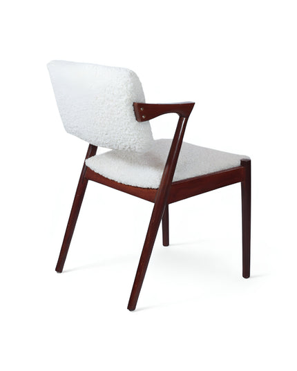 Mid-century modern accent chair featuring an angular dark wood frame and plush white bouclé upholstery on the seat and backrest, perfect for living rooms, reading corners, or contemporary lounge spaces.