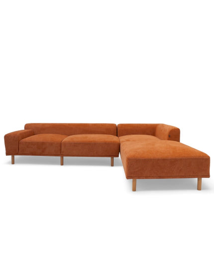 Modern orange modular sofa with two deep-seating sections, ergonomic spring cushions, and elevated wooden legs designed for lounging and easy cleaning