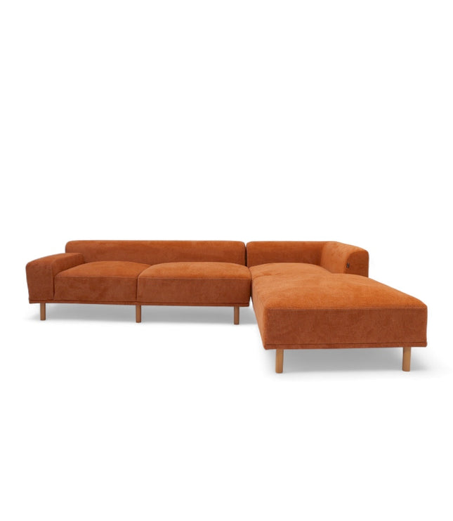 Modern orange modular sofa with two deep-seating sections, ergonomic spring cushions, and elevated wooden legs designed for lounging and easy cleaning