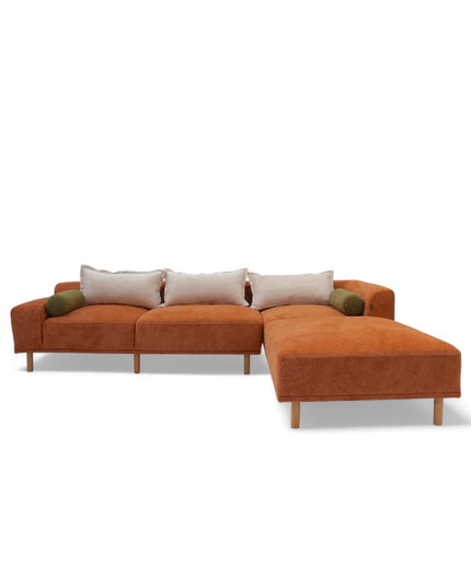 Modern orange modular sofa with two deep-seating sections, ergonomic spring cushions, and elevated wooden legs designed for lounging and easy cleaning