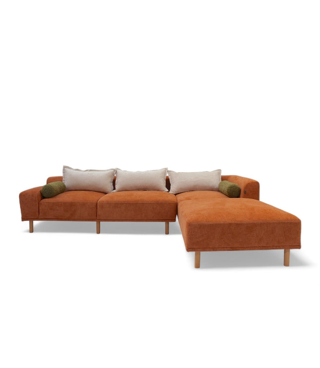 Modern orange modular sofa with two deep-seating sections, ergonomic spring cushions, and elevated wooden legs designed for lounging and easy cleaning