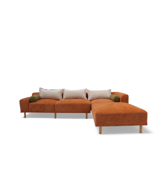 Modern orange modular sofa with two deep-seating sections, ergonomic spring cushions, and elevated wooden legs designed for lounging and easy cleaning