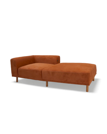 Modern orange modular sofa with two deep-seating sections, ergonomic spring cushions, and elevated wooden legs designed for lounging and easy cleaning