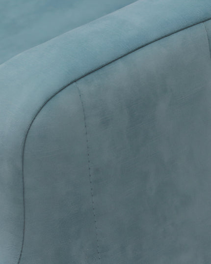 Contemporary blue lounge chair with a pull-out sleeper function and a soft pink accent pillow, featuring plush upholstery and modern lines—ideal for small spaces or guest rooms.