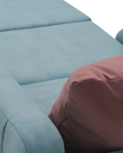 Contemporary blue lounge chair with a pull-out sleeper function and a soft pink accent pillow, featuring plush upholstery and modern lines—ideal for small spaces or guest rooms.
