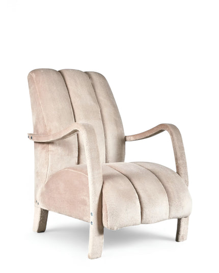 Aura Armchair in beige velvet-style upholstery with scalloped backrest, sculptural arms, and seamless upholstered legs; shown from front-angle, side, and rear perspectives.
