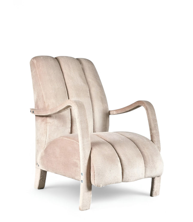 Aura Armchair in beige velvet-style upholstery with scalloped backrest, sculptural arms, and seamless upholstered legs; shown from front-angle, side, and rear perspectives.
