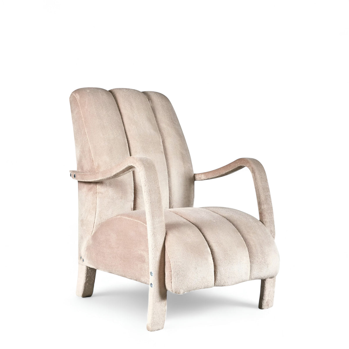 Aura Armchair in beige velvet-style upholstery with scalloped backrest, sculptural arms, and seamless upholstered legs; shown from front-angle, side, and rear perspectives.