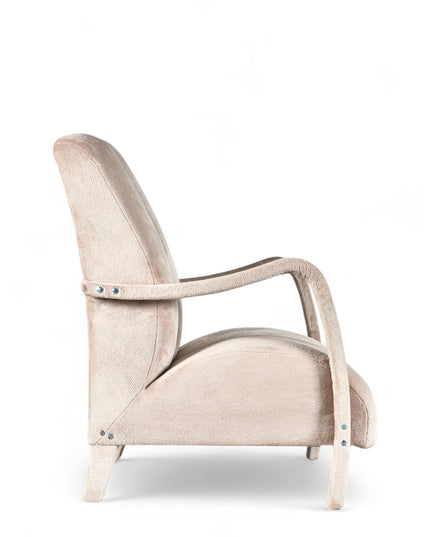 Aura Armchair in beige velvet-style upholstery with scalloped backrest, sculptural arms, and seamless upholstered legs; shown from front-angle, side, and rear perspectives.
