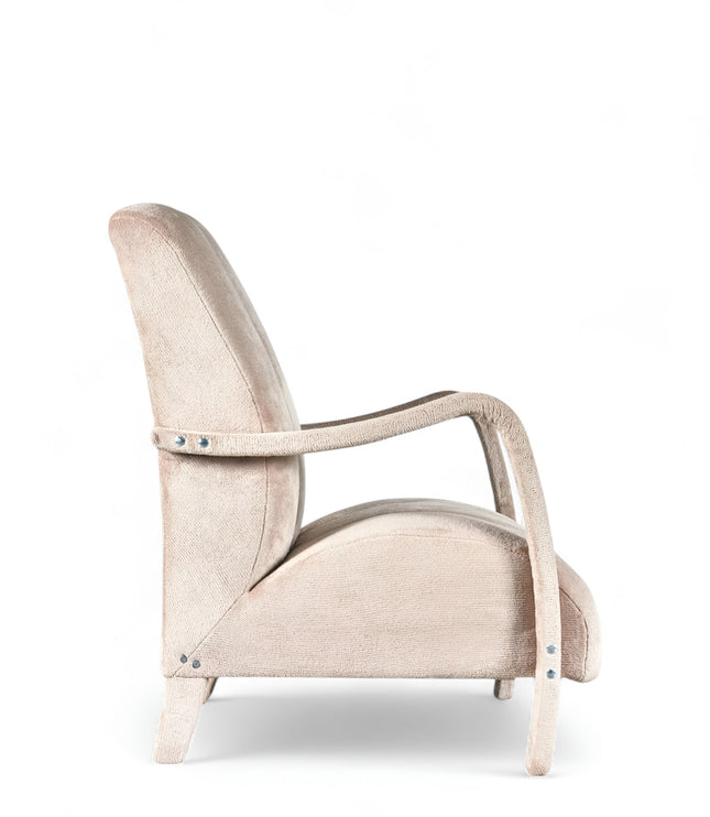 Aura Armchair in beige velvet-style upholstery with scalloped backrest, sculptural arms, and seamless upholstered legs; shown from front-angle, side, and rear perspectives.
