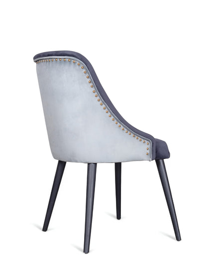 Contemporary side chair with two colors of blue curved backrest, studded trim, and black tapered legs