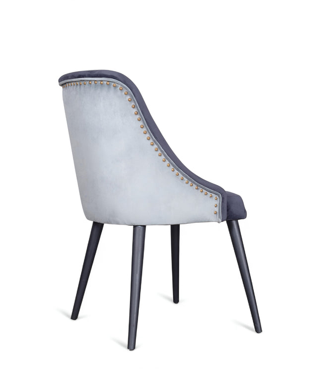 Contemporary side chair with two colors of blue curved backrest, studded trim, and black tapered legs