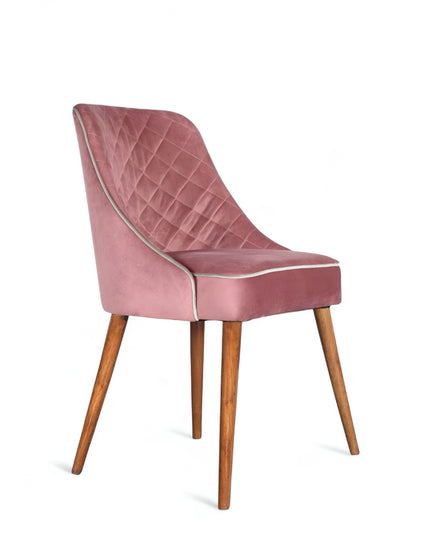 Contemporary side chair with pink curved backrest, studded trim, and wooden legs