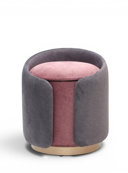 A cylindrical upholstered ottoman or stool in dusty grey velvet, featuring a light natural wood base, shown against a plain white background.