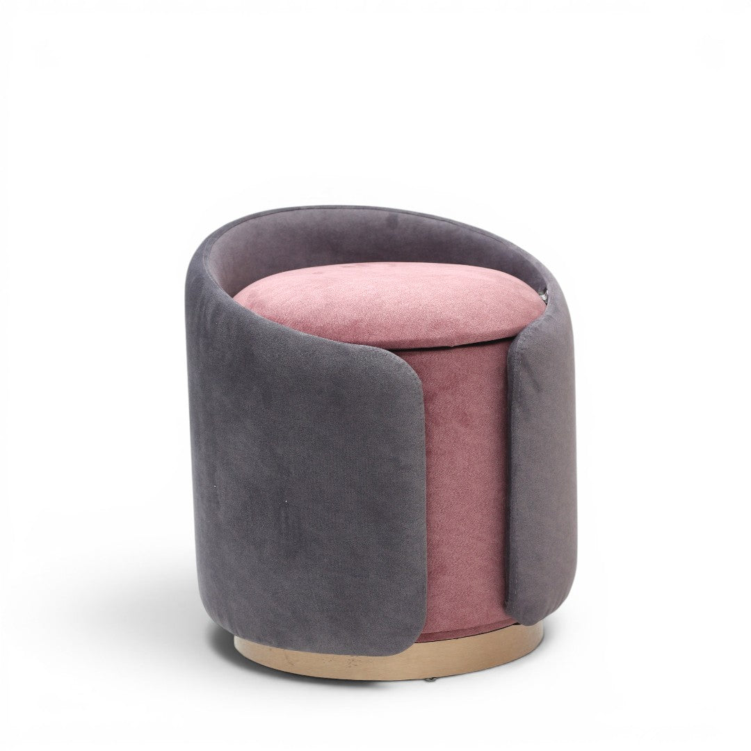 A cylindrical upholstered ottoman or stool in dusty grey velvet, featuring a light natural wood base, shown against a plain white background.