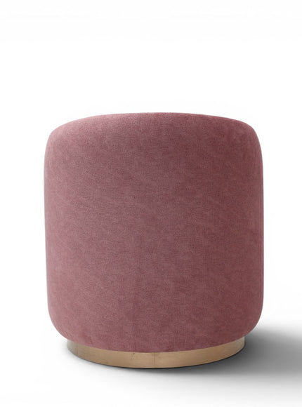 A cylindrical upholstered ottoman or stool in dusty rose pink velvet, featuring a light natural wood base, shown against a plain white background.