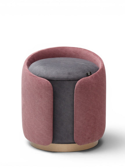 A cylindrical upholstered ottoman or stool in dusty rose pink velvet, featuring a light natural wood base, shown against a plain white background.