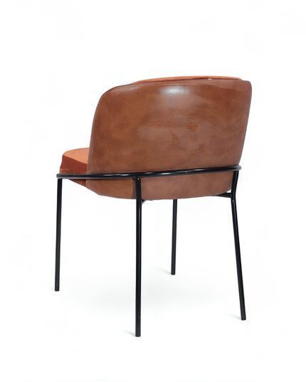 Modern terracotta velvet and leather accent chair with black metal legs — ideal for dining rooms, stylish interiors, or contemporary cafes seeking warmth and contrast.