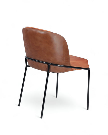 Modern terracotta velvet and leather accent chair with black metal legs — ideal for dining rooms, stylish interiors, or contemporary cafes seeking warmth and contrast.