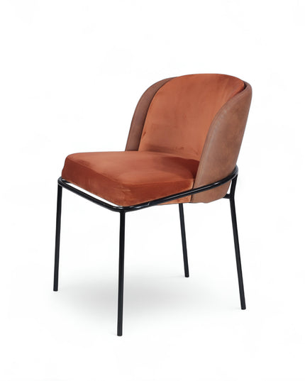 Modern terracotta velvet and leather accent chair with black metal legs — ideal for dining rooms, stylish interiors, or contemporary cafes seeking warmth and contrast.