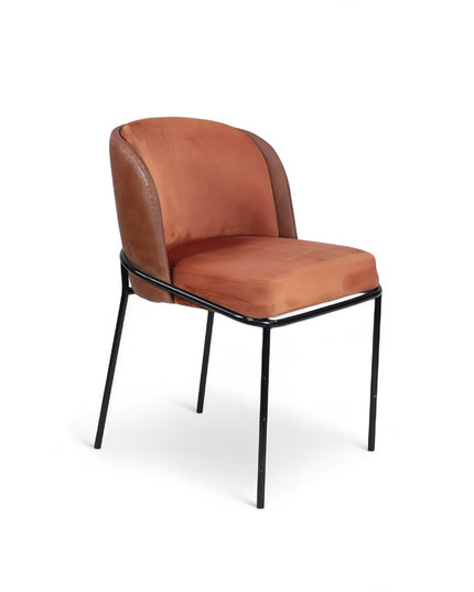 Modern terracotta velvet and leather accent chair with black metal legs — ideal for dining rooms, stylish interiors, or contemporary cafes seeking warmth and contrast.