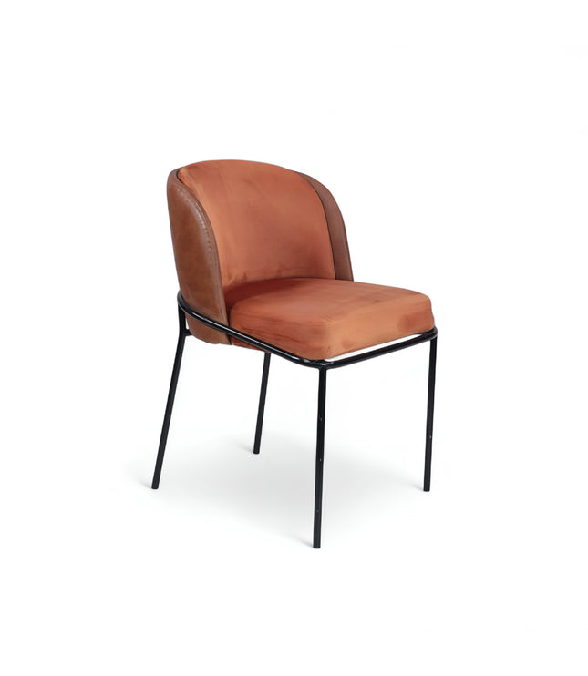 Modern terracotta velvet and leather accent chair with black metal legs — ideal for dining rooms, stylish interiors, or contemporary cafes seeking warmth and contrast.