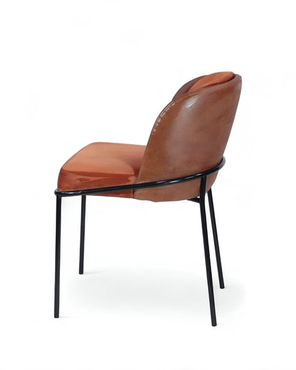 Modern terracotta velvet and leather accent chair with black metal legs — ideal for dining rooms, stylish interiors, or contemporary cafes seeking warmth and contrast.