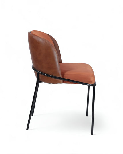 Modern terracotta velvet and leather accent chair with black metal legs — ideal for dining rooms, stylish interiors, or contemporary cafes seeking warmth and contrast.