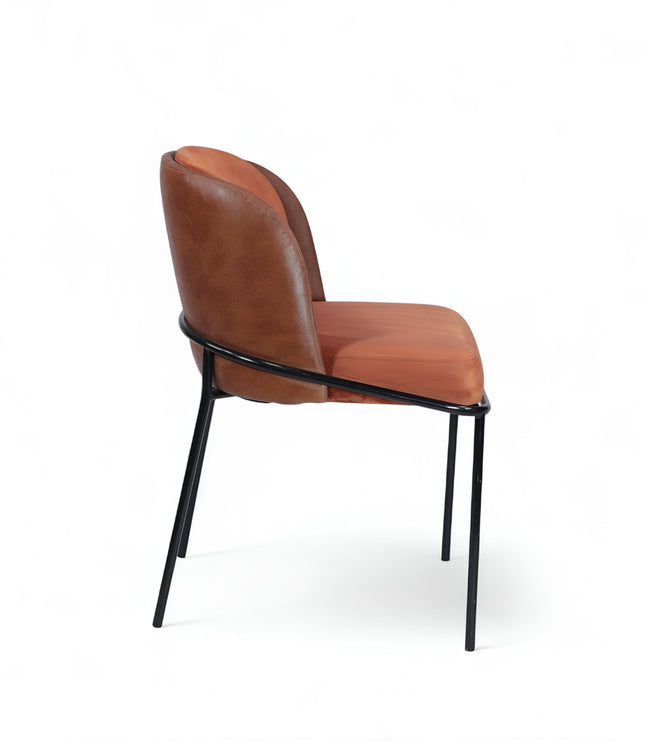 Modern terracotta velvet and leather accent chair with black metal legs — ideal for dining rooms, stylish interiors, or contemporary cafes seeking warmth and contrast.