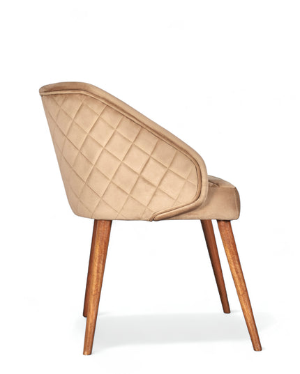 Modern quilted beige accent chair with wraparound back, low arms, and wooden tapered legs
