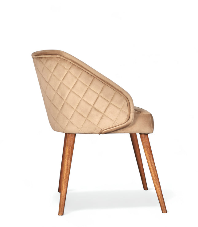 Modern quilted beige accent chair with wraparound back, low arms, and wooden tapered legs

