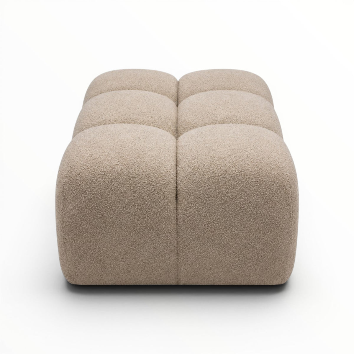 Beige cube-shaped ottoman on a white background