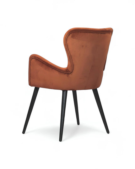 Mid-century modern burnt orange velvet accent chair with black metal legs, ideal for living room or office decor.