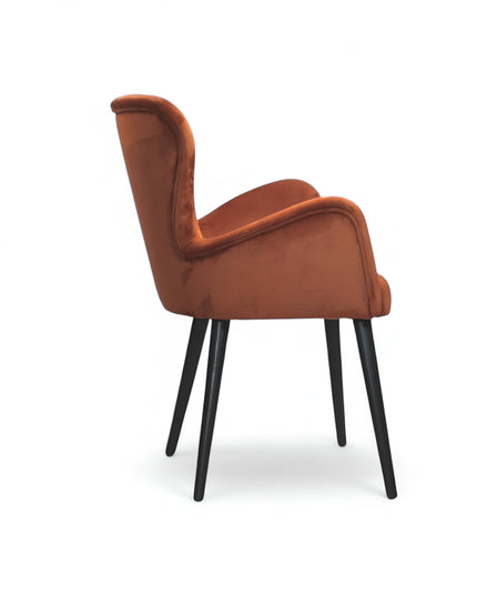 Mid-century modern burnt orange velvet accent chair with black metal legs, ideal for living room or office decor.