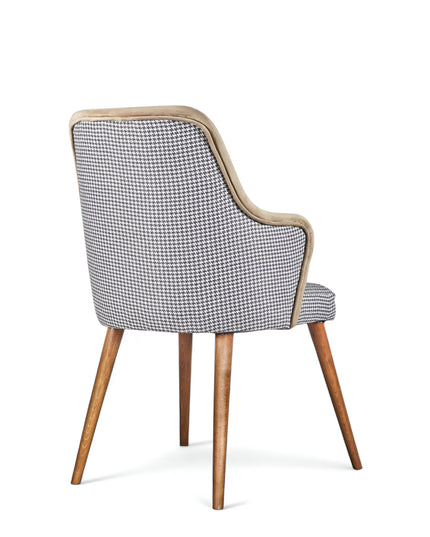 Houndstooth/beige upholstered armchair with high back, quilted sides, and wooden legs in a mid-century modern style