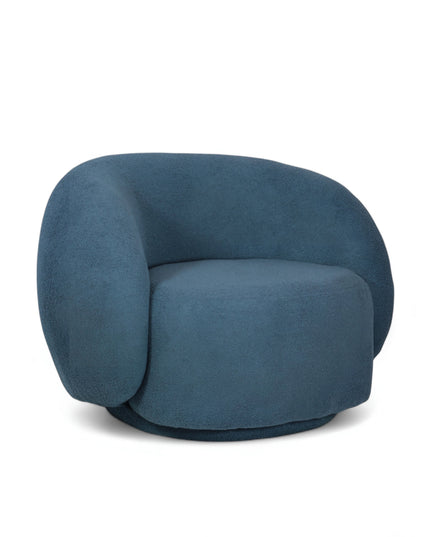 Deep blue boucle Cloud Armchair with a rounded, armless design and swivel base, offering a plush, sculptural look from front and angled views.