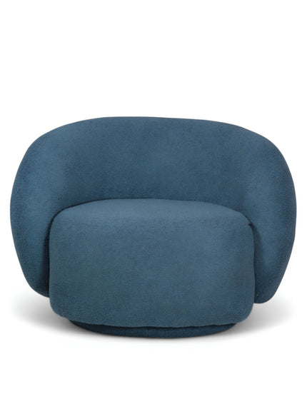Deep blue boucle Cloud Armchair with a rounded, armless design and swivel base, offering a plush, sculptural look from front and angled views.