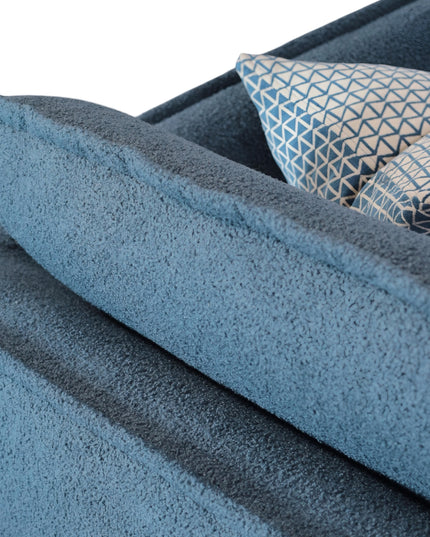 Cobalt Sofa in boucle-style blue fabric with slim black metal legs, rounded arms, and two patterned accent pillows, shown from front view and close-up fabric detail.